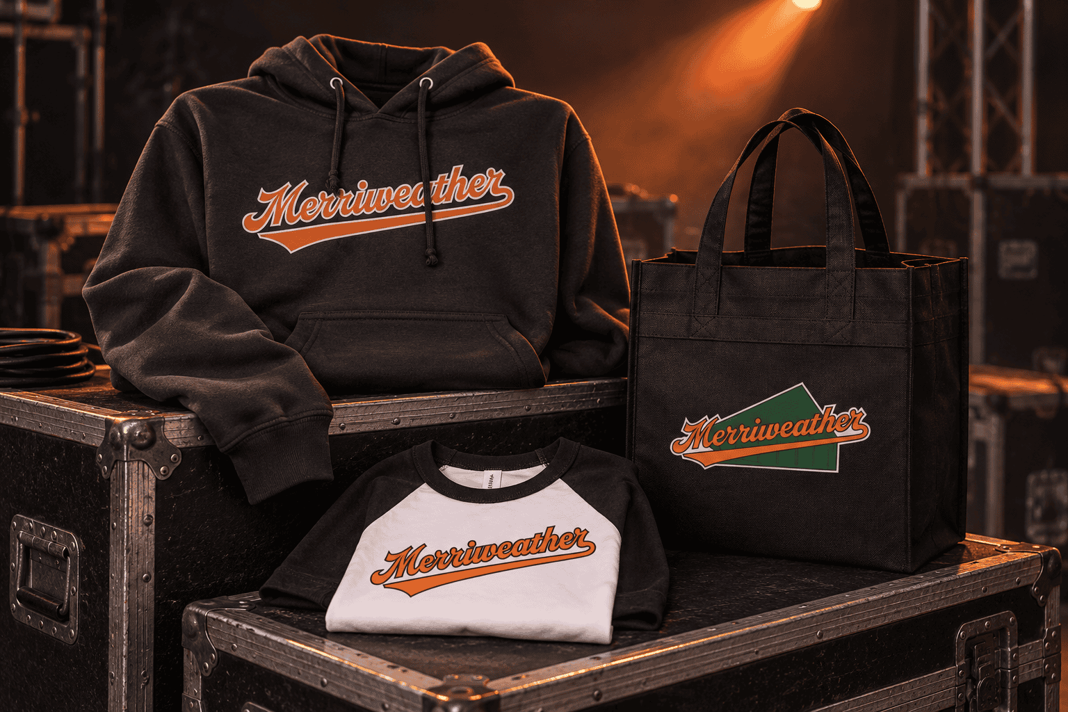 Merriweather hoodie, raglan tee and tote bag on road cases, lit like a stage