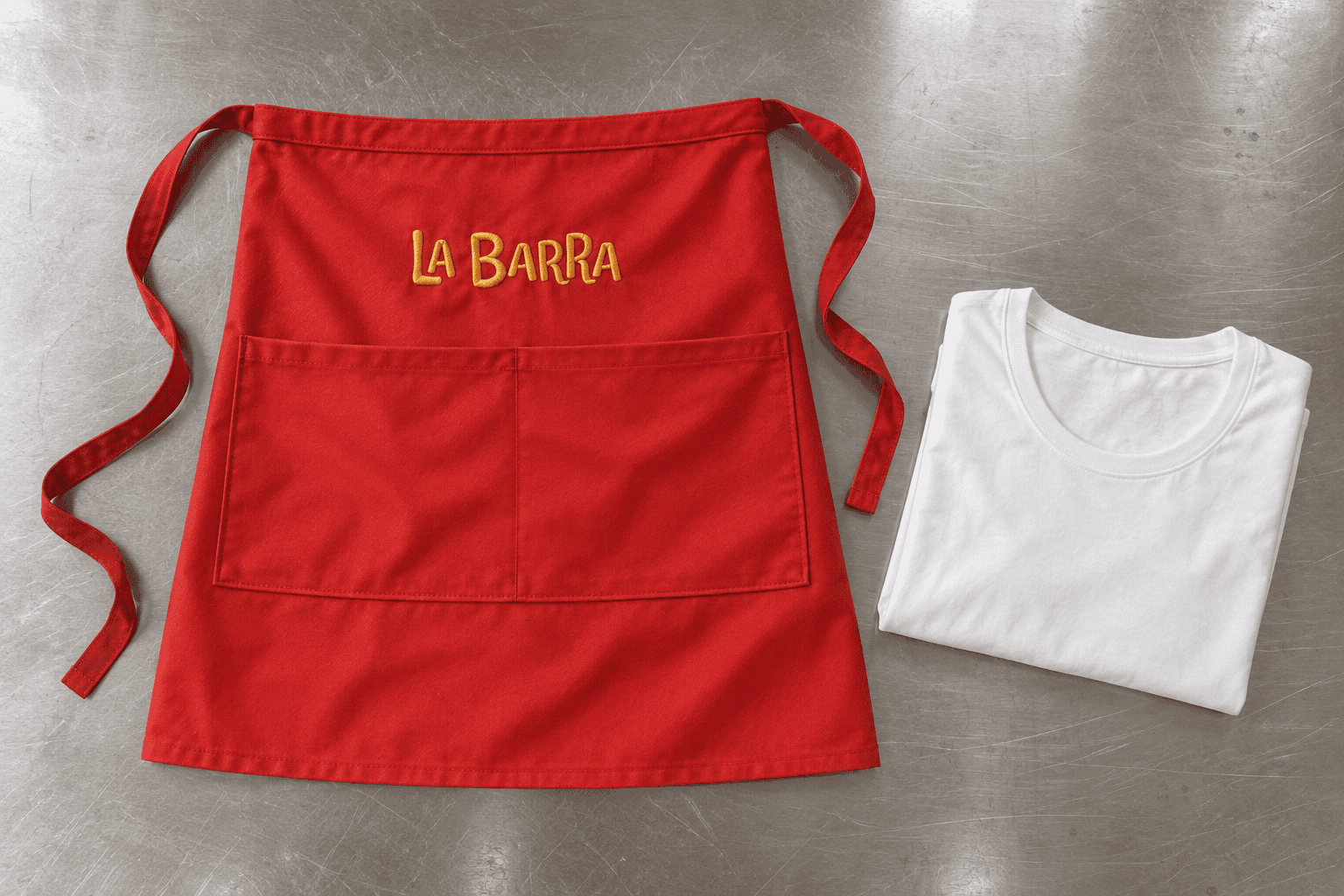 Red La Barra apron and folded white T-shirt