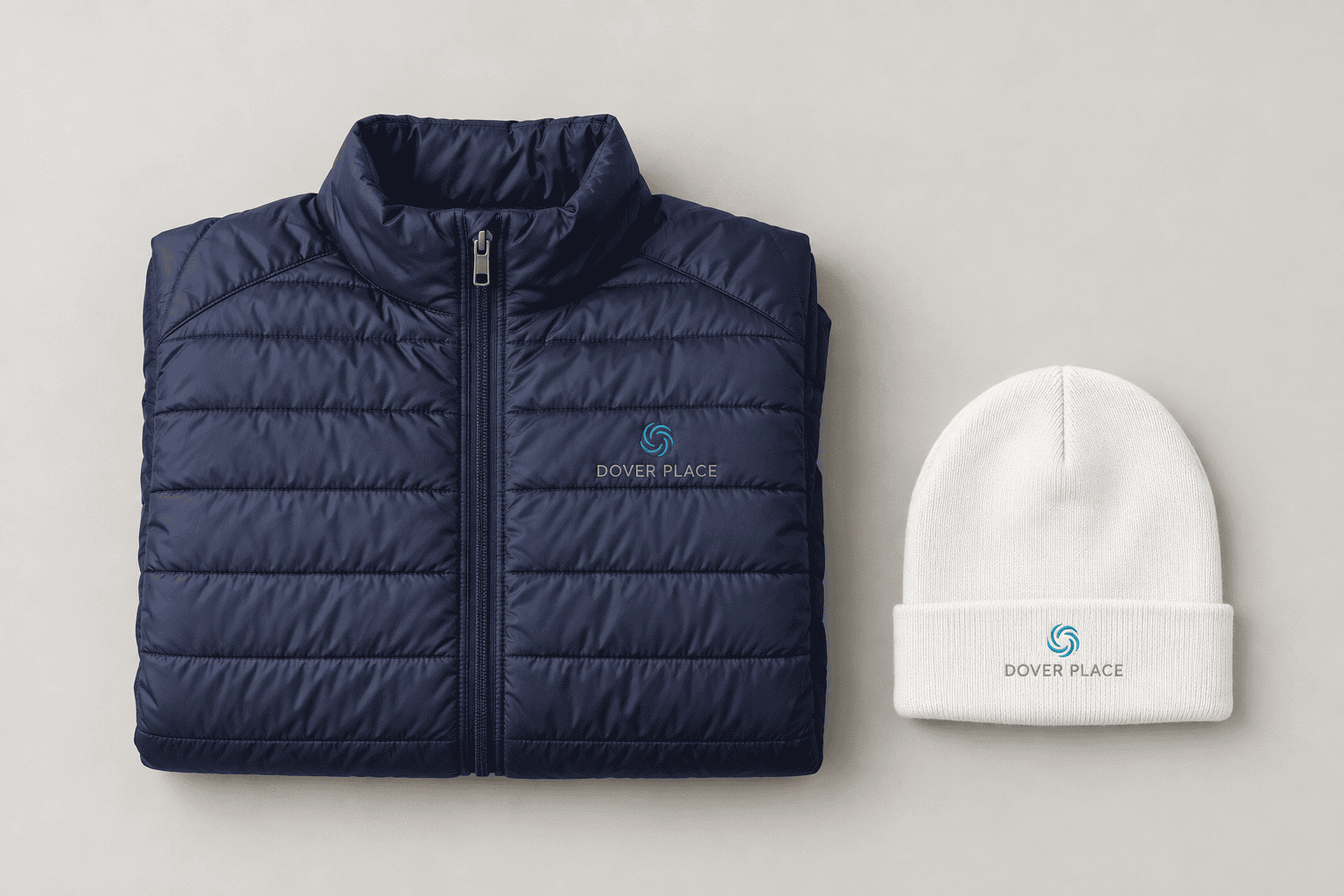 Navy puffer vest and white beanie with the Dover Place logo